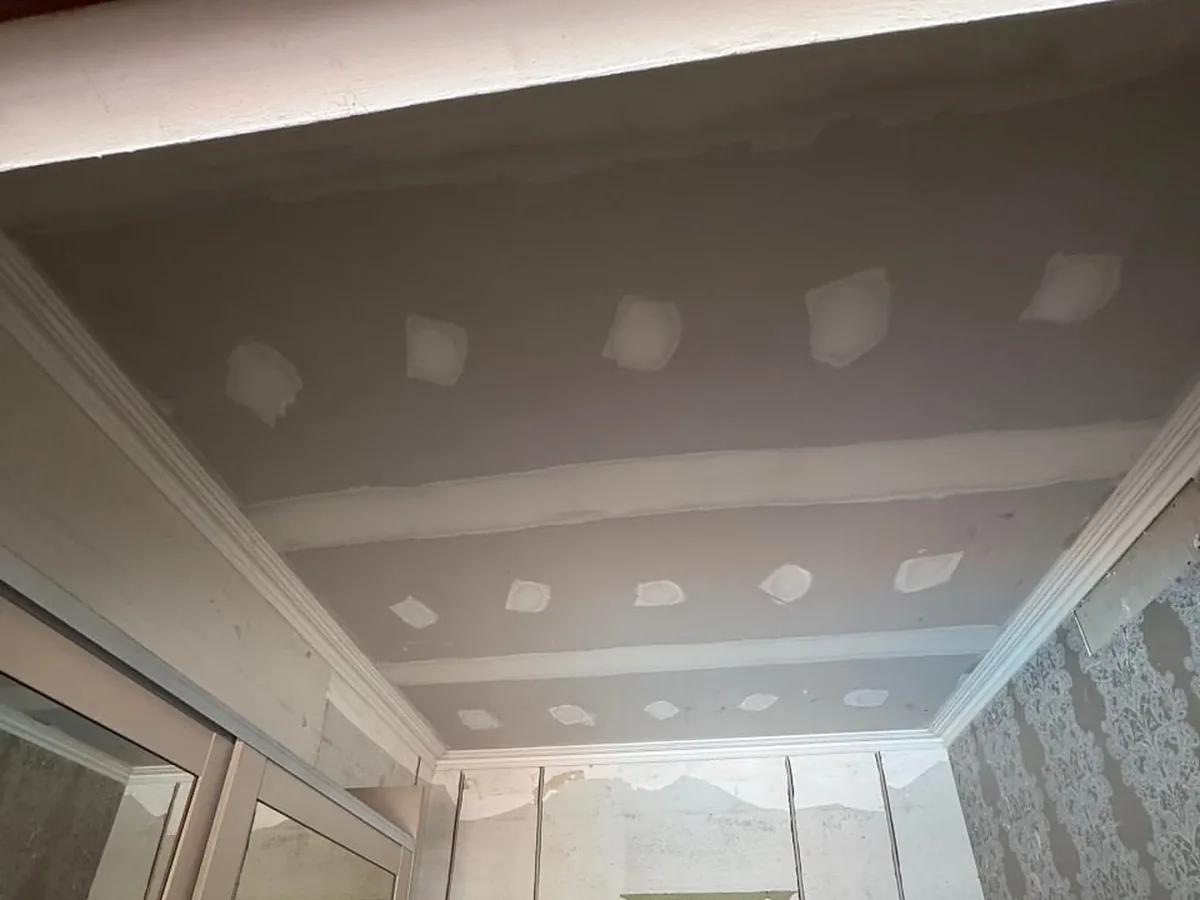 Bedroom ceiling resheeted and set, screw holes patched and cornice line refitted