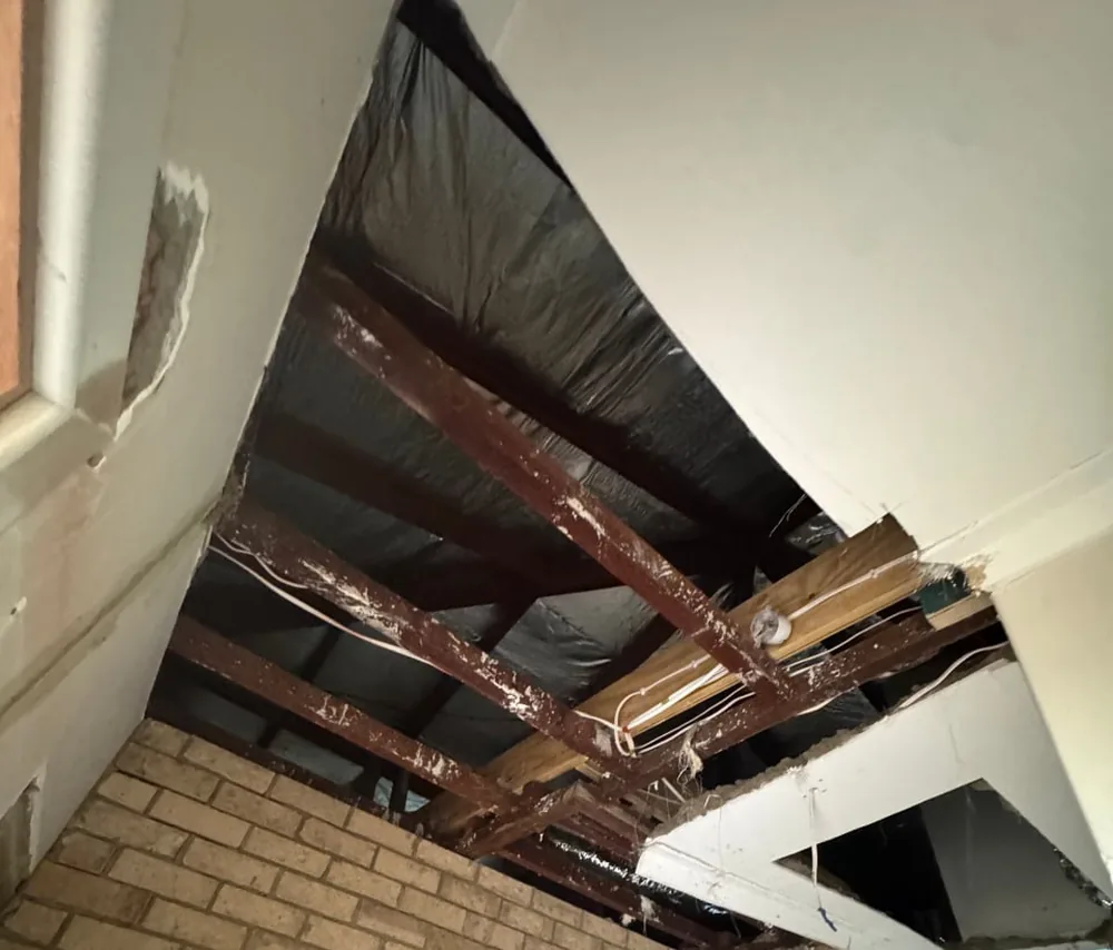 Ceiling stripped back to the rafters with the sarking exposed, ready for new board