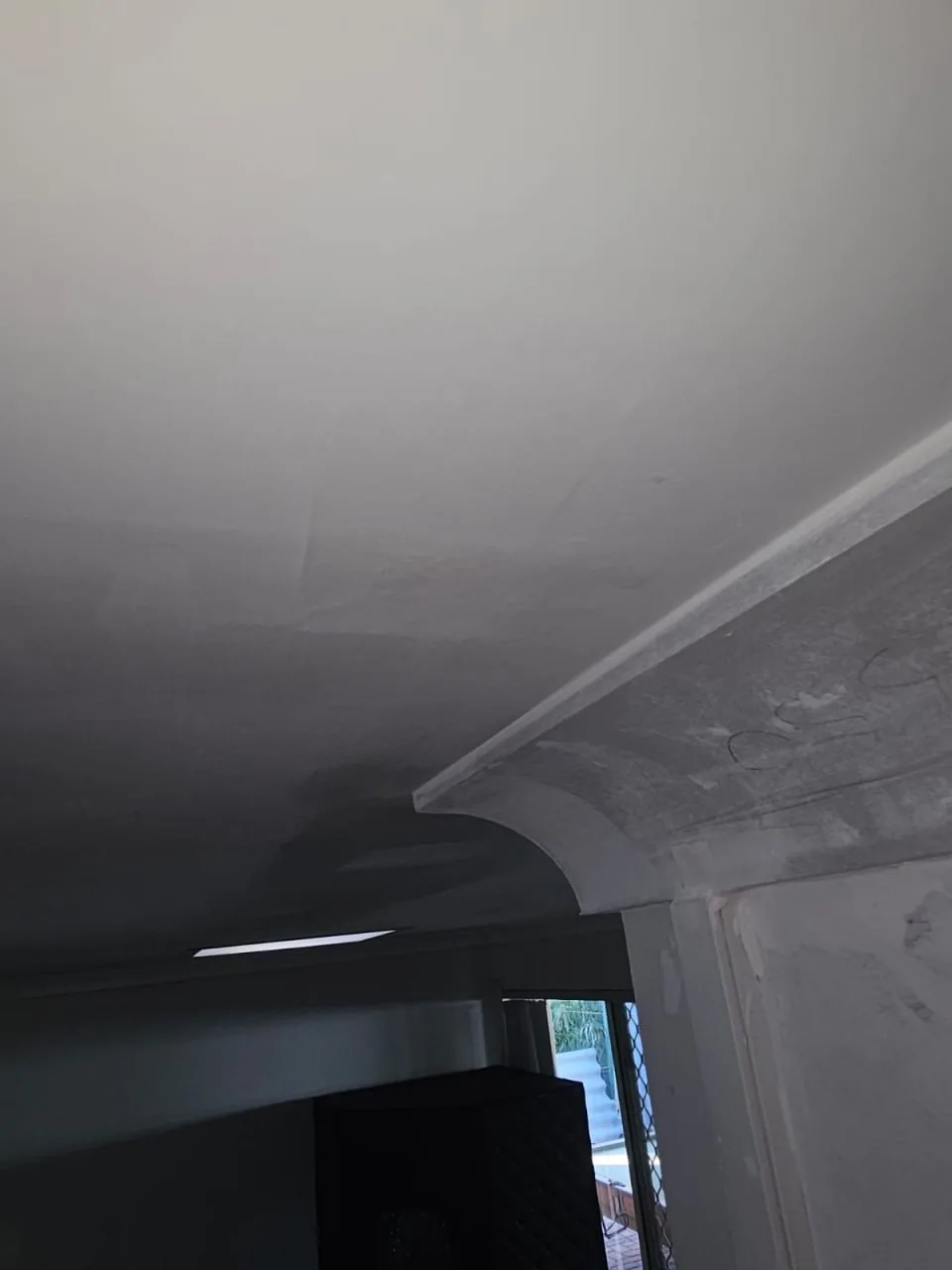 Close view of the junction between the ceiling and the plaster cornice in a Bassendean home, with water marks tracking down the face of the cornice