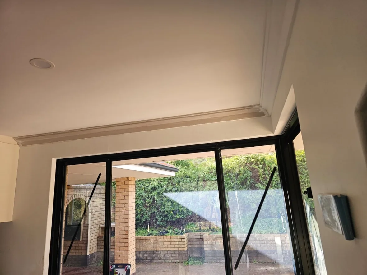 A new ceiling and cornice above the sliding doors of a Roleystone house, looking out to the garden